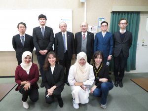 International students with the university president and faculty